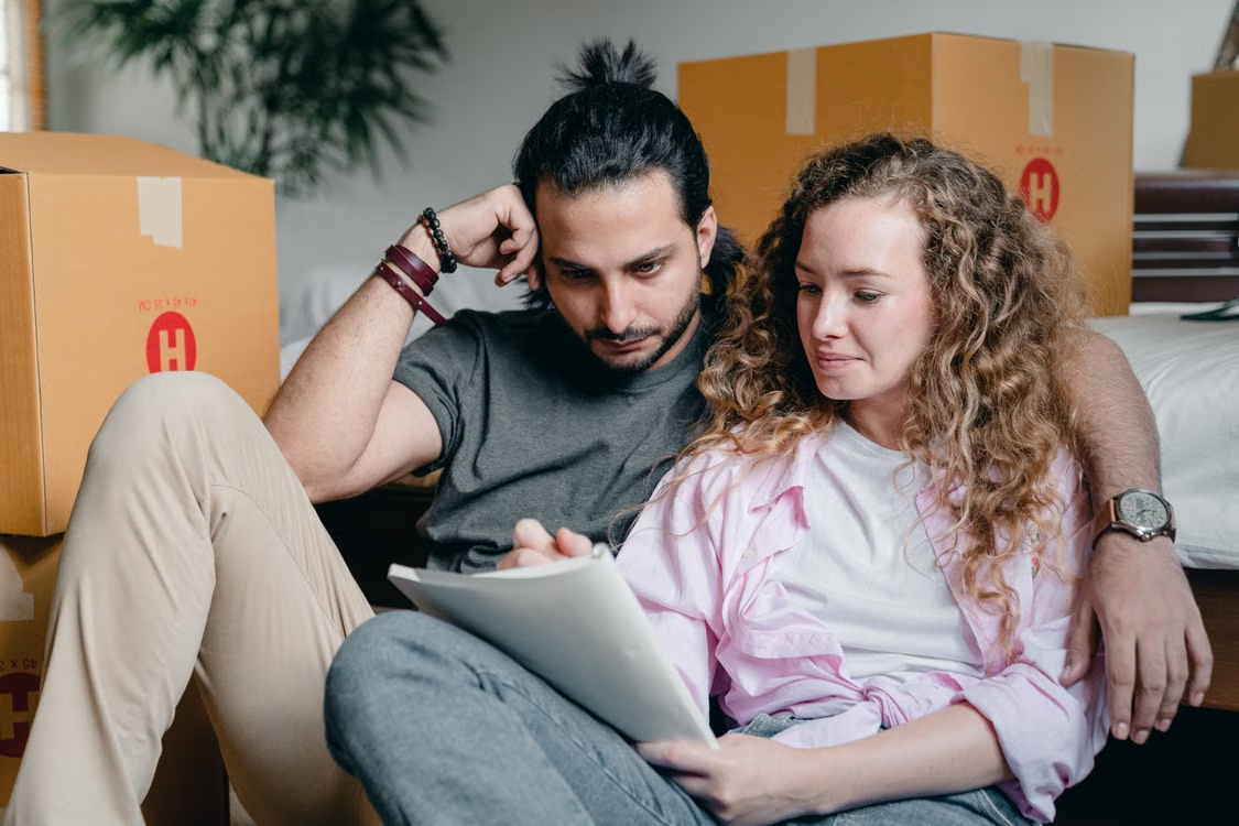 A couple writing something down in a notebook